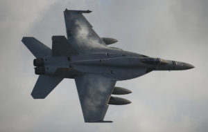 An F/A-18E Super Hornet assigned to Strike Fighter Squadron (VFA) 81 flies over the Nimitz-class aircraft carrier USS Carl Vinson (CVN 70). Carl Vinson and Carrier Air Wing (CVW) 17 are underway on a western Pacific deployment.